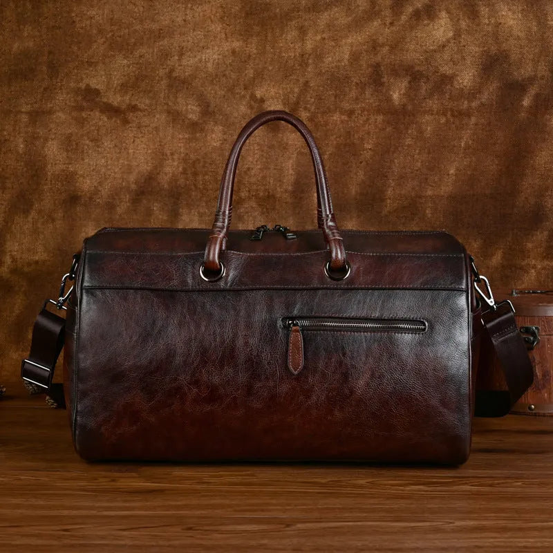 Handmade retro brown leather satchel with large capacity and an expandable design.