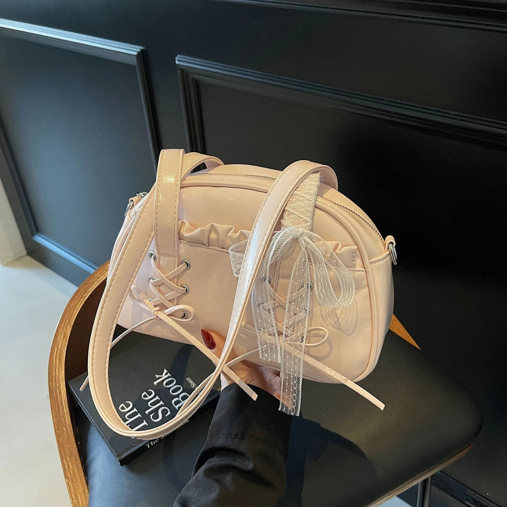 Women's bandage bow handbag in milky white colour with adjustable bow detail and internal mobile phone compartment