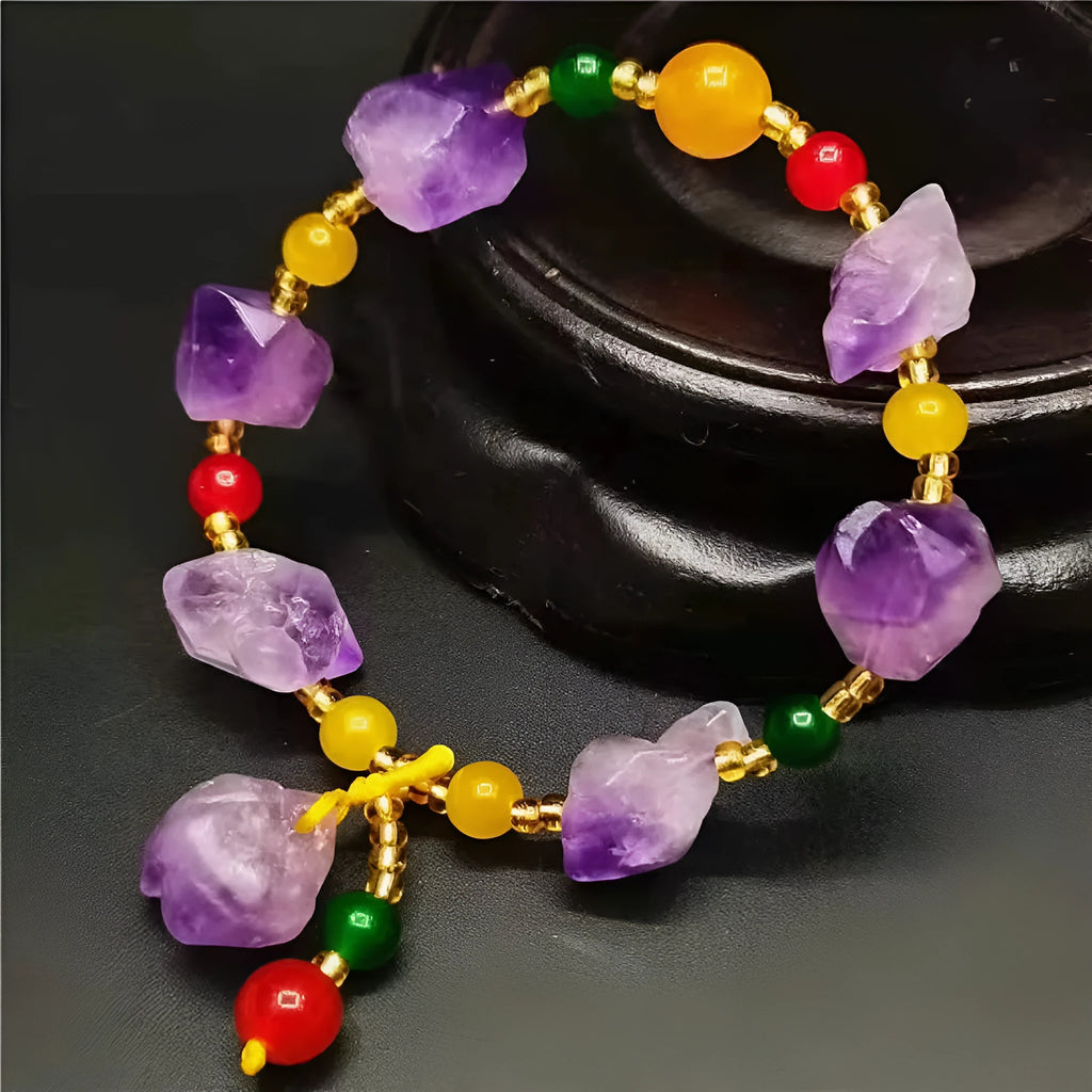 A natural style women's bracelet made with amethyst-shaped beads and a decorative fu character.