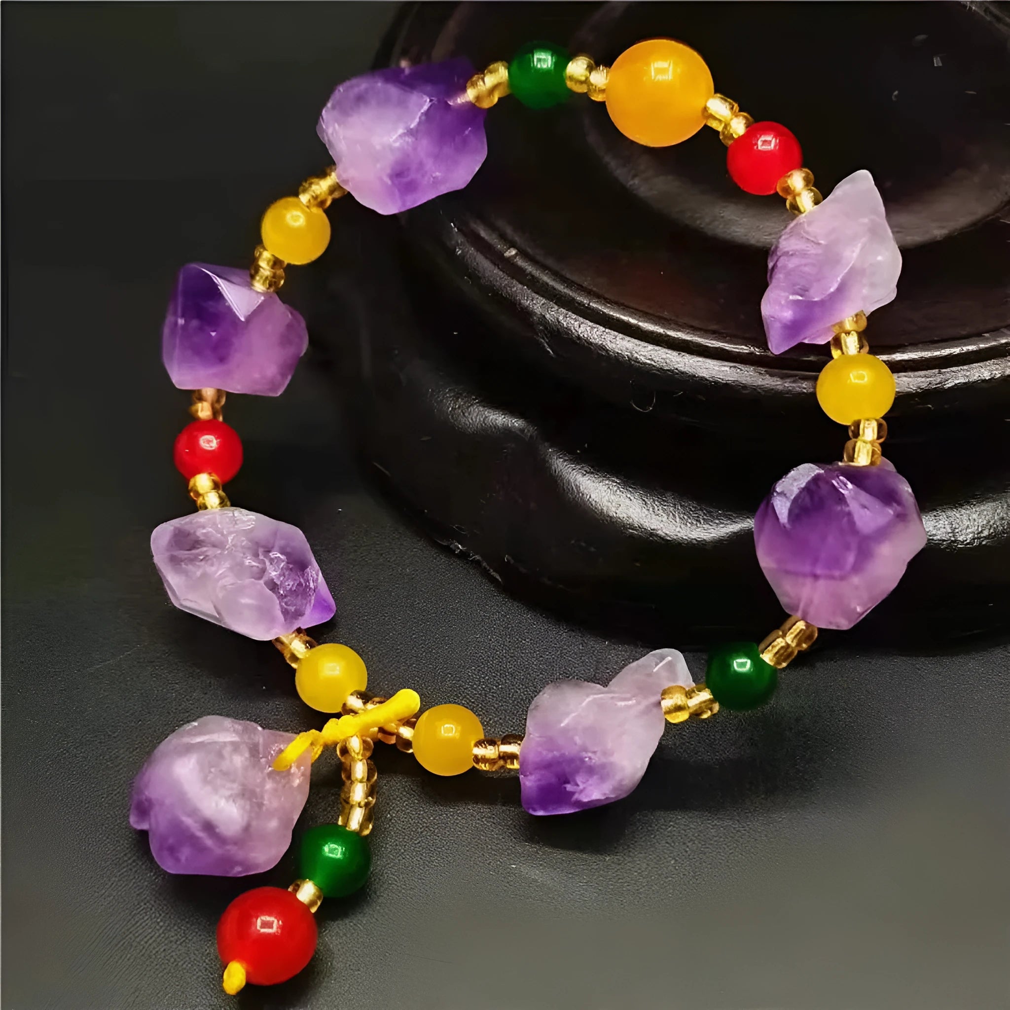 A natural style women's bracelet made with amethyst-shaped beads and a decorative fu character.