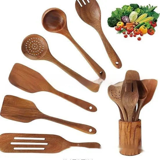 A set of seven wooden kitchen utensils including various spoons and spatulas on a table.