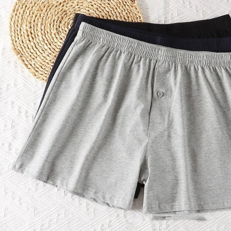 Men's loose fit pure cotton boxer shorts in black, light grey, and navy blue.