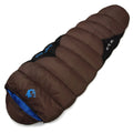Brown cotton camping sleeping bag partially rolled next to its grey compression storage sack.
