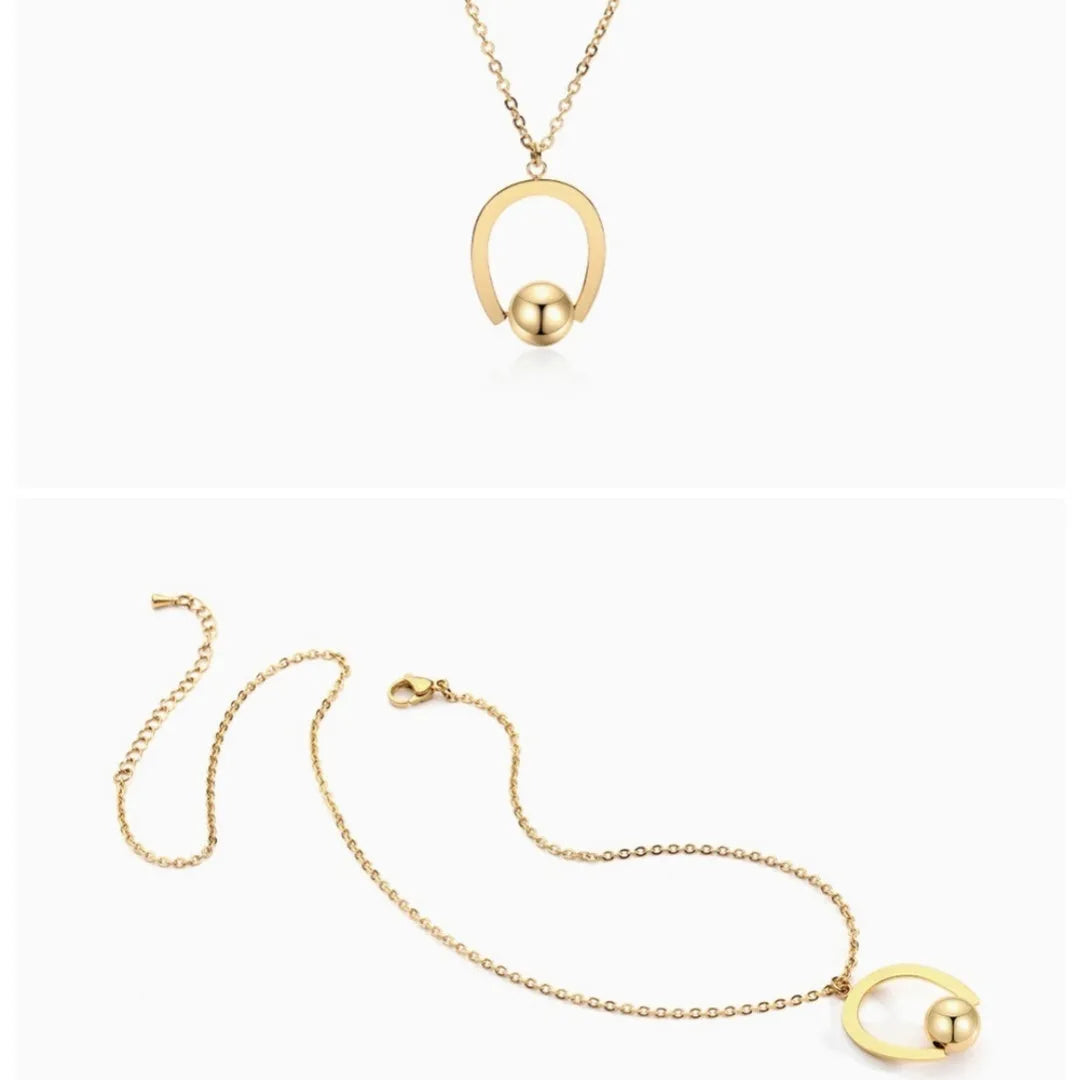 Stainless steel geometric pendant necklace on a cross chain, shown in gold colour.