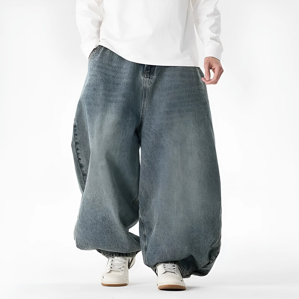 Men's loose fit plus size jeans in dark blue denim showing wide leg and low waist style.