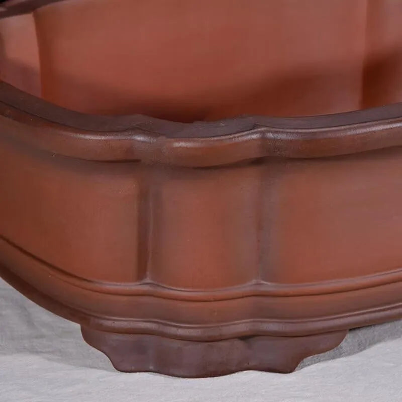 Large oval antique-finish purple clay flowerpot with carved crabapple tree design.