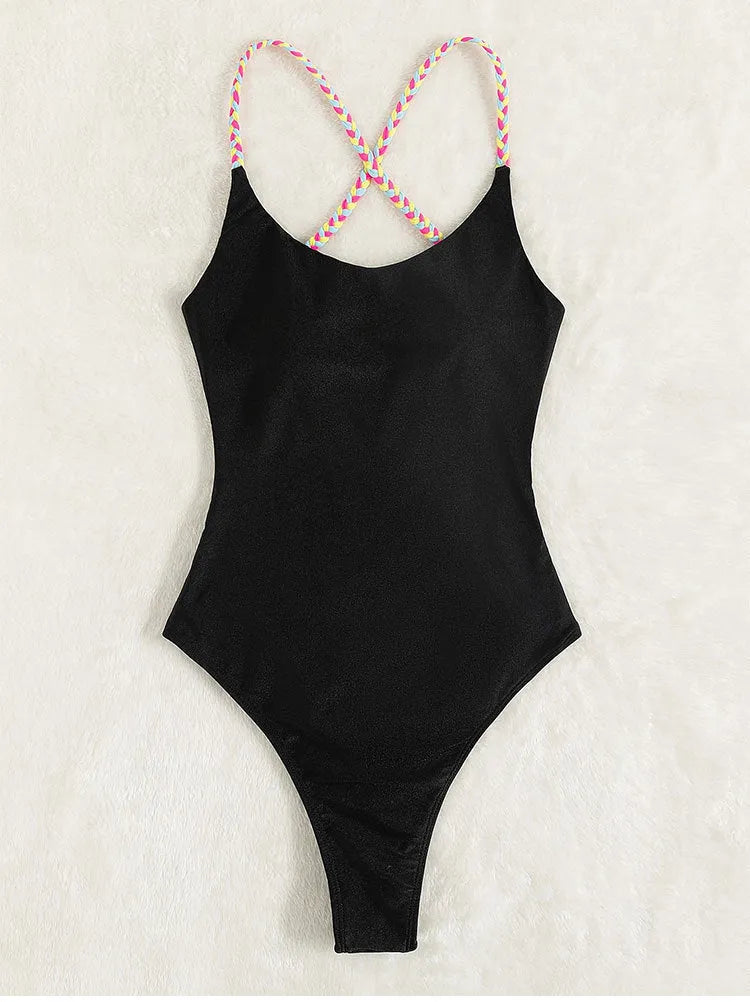 Black solid colour backless one-piece swimsuit for women on a hanger.