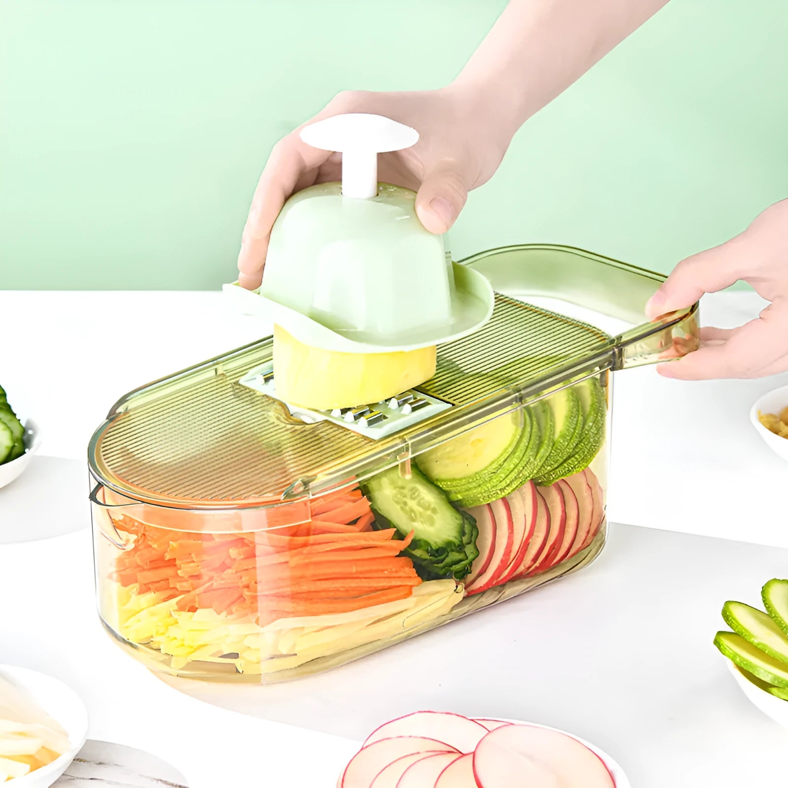 Transparent green kitchen chopper with stainless steel blades and optional drain basket on countertop