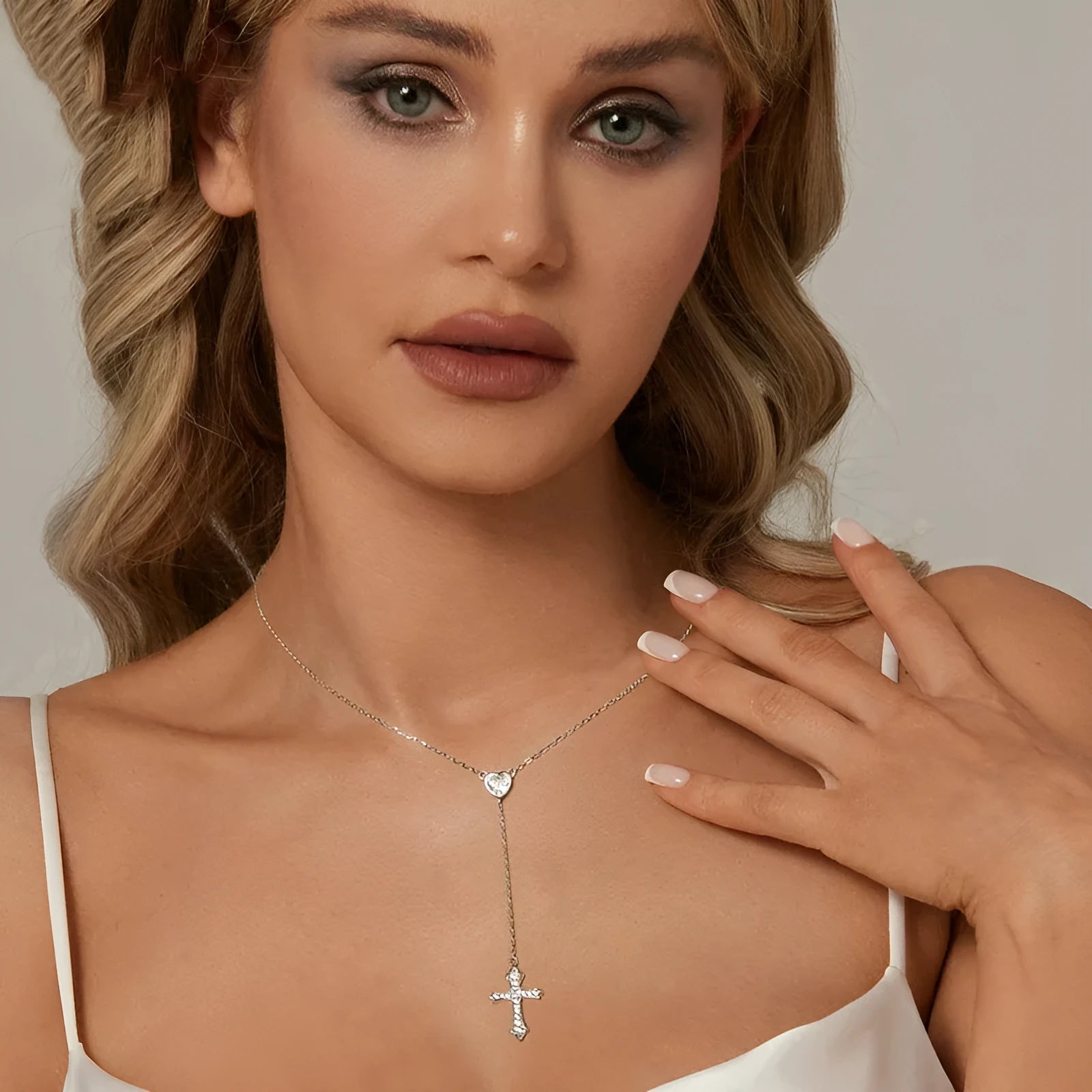 Close-up of a sterling silver V-neck cross pendant on an O-ring chain, colour BSN384.