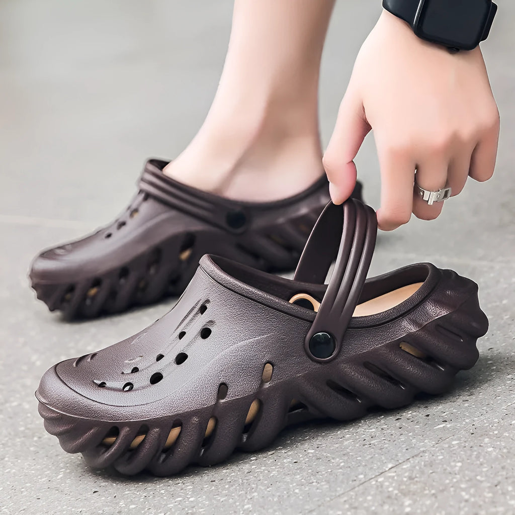 Men's beige EVA slipper sandals with hollow out design and round toe on a non-slip sole.