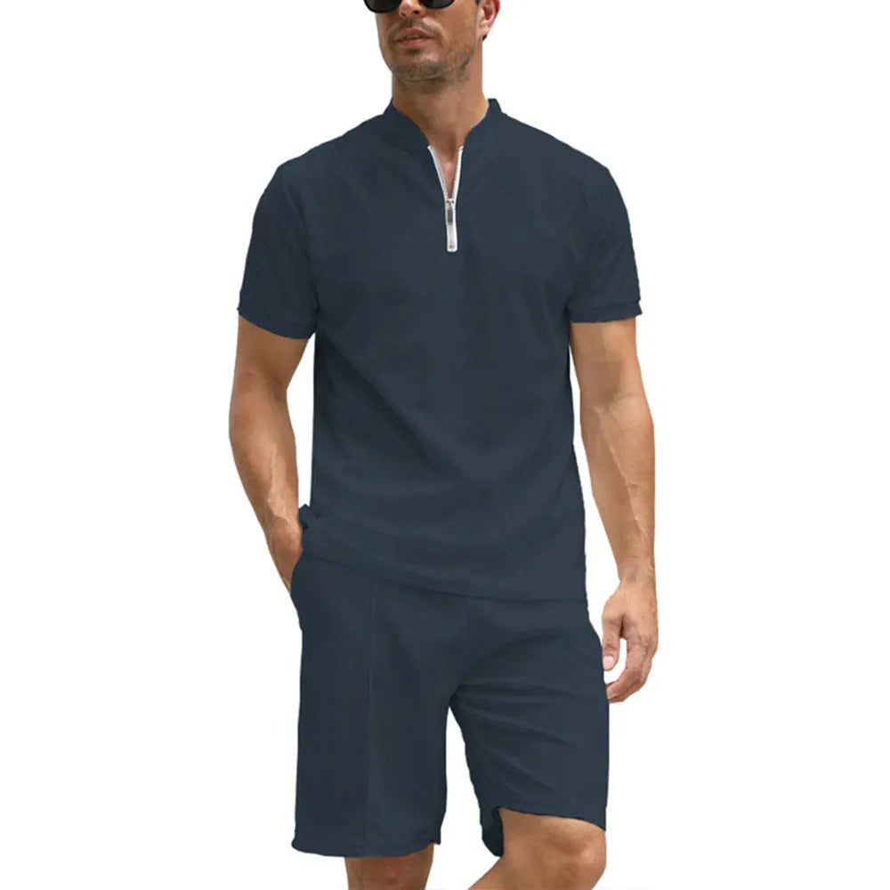 Men's solid colour polo shirt and matching trousers two-piece set on a hanger.