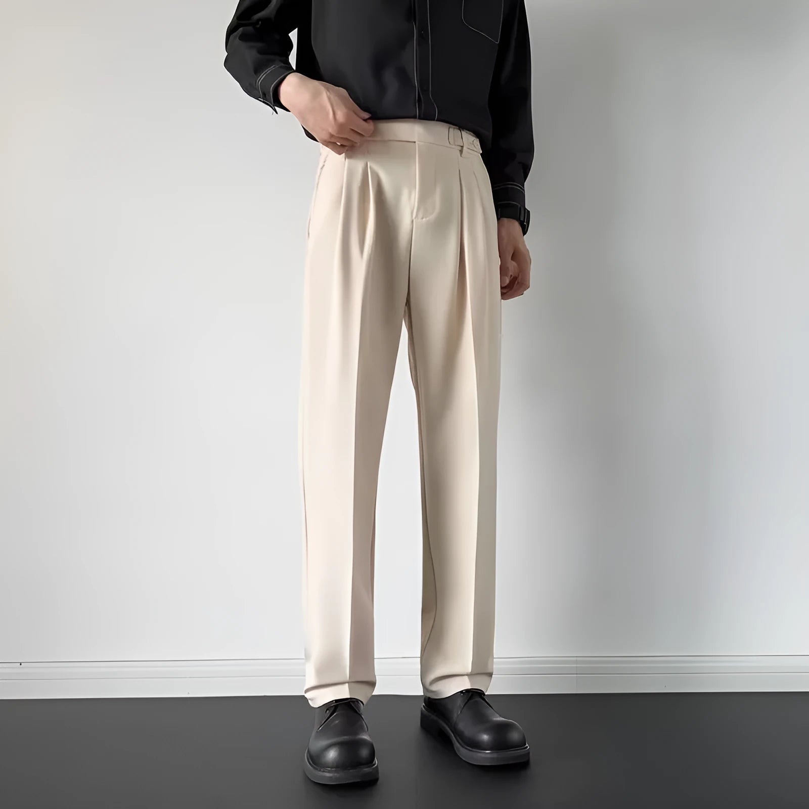 Men's straight loose fit suit trousers in apricot colour on a hanger.