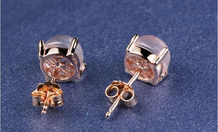 Rose gold drop-shaped stud earrings with synthetic ross quartz crystal inlay