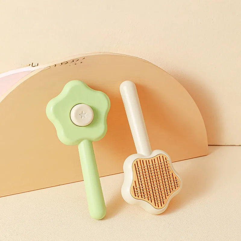 Green self-cleaning magic wand cat comb with stainless steel needle teeth on a white background.
