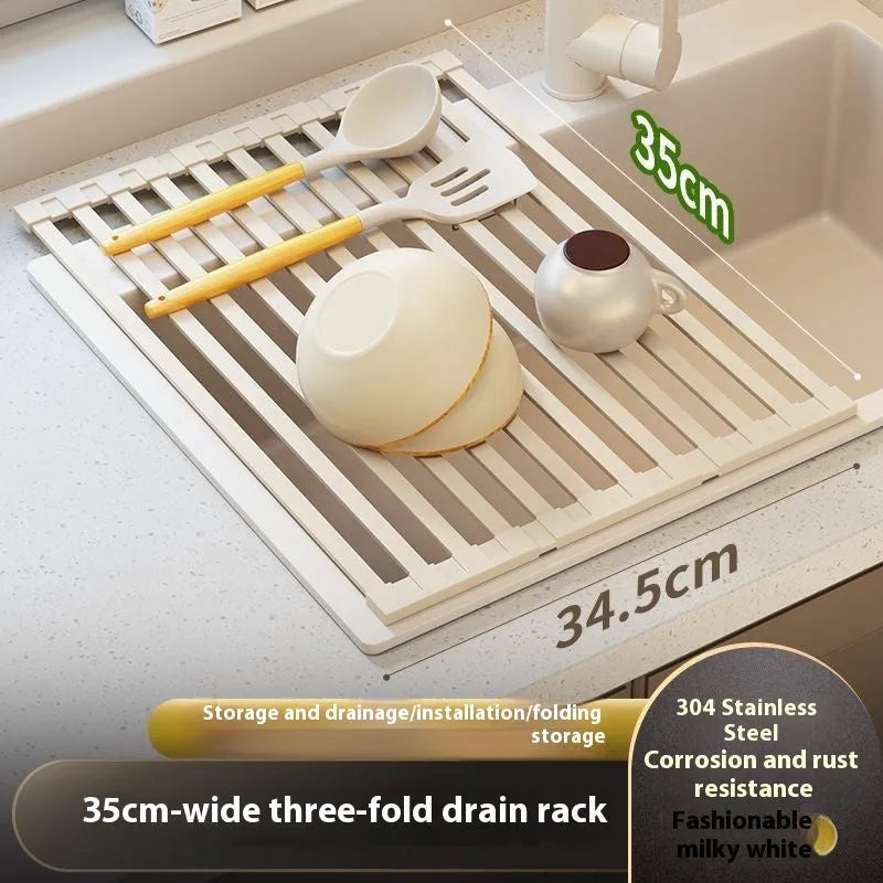Foldable milky white stainless steel kitchen draining rack beside a sink