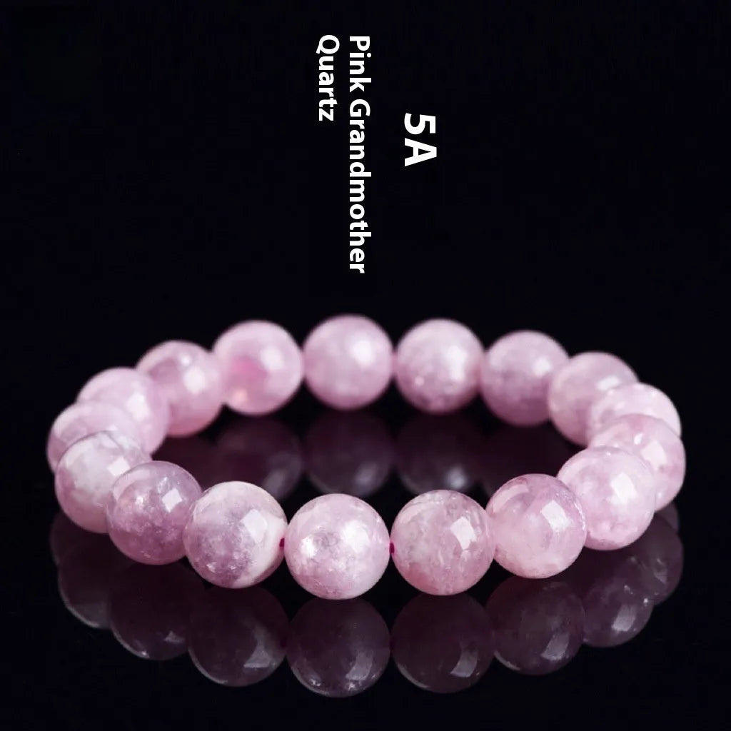 Grandmother Crystal Bracelet with polished purple beads in geometric shapes on a wrist.