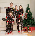 Family matching Christmas pajamas set in plaid and cartoon prints, showing adult, child, and dog sizes.