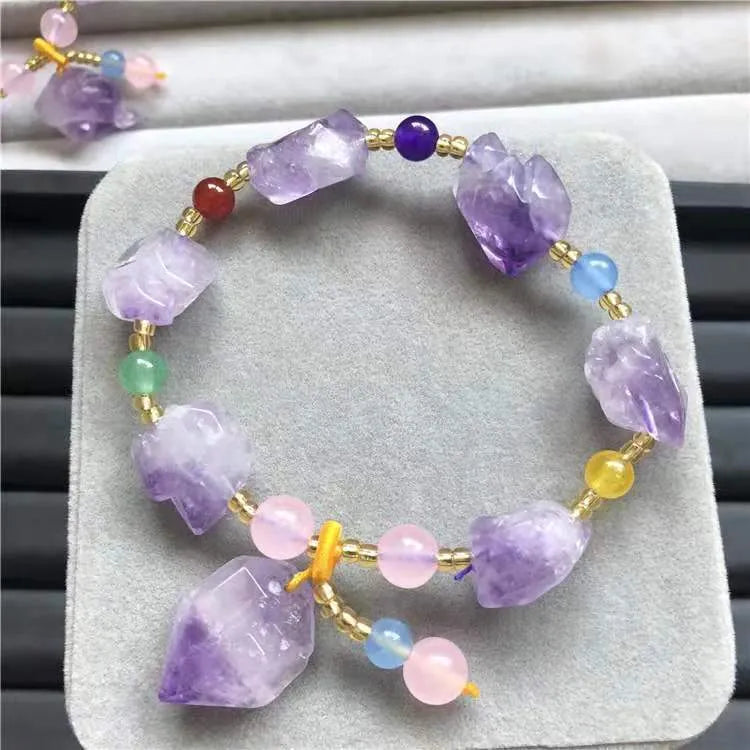 A natural style women's bracelet made with amethyst-shaped beads and a decorative fu character.