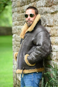 Men's brown synthetic leather retro fur coat for winter on a hanger.