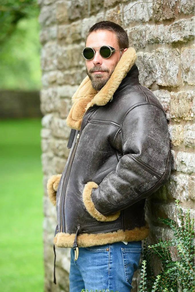 Men's brown synthetic leather retro fur coat for winter on a hanger.