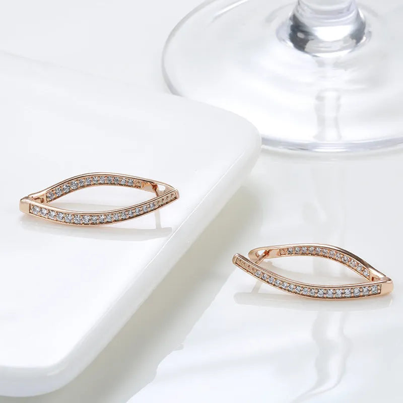 A pair of geometric drop earrings with a clear zircon stone and copper posts, colour H0493.