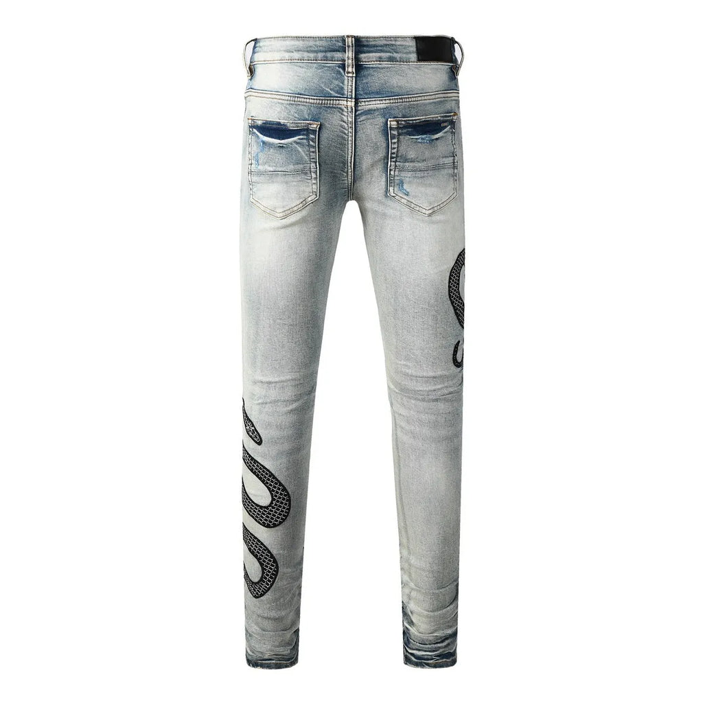 Man's blue distressed skinny jeans with a street fashion wash and button fly.