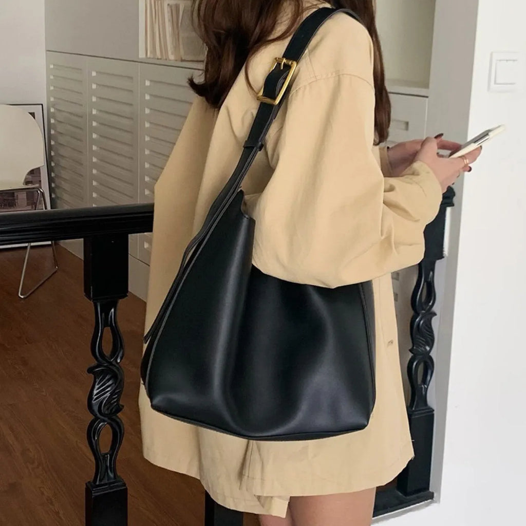 Women's soft PU leather crossbody bag with swing threads detail showing black ribbon colour option