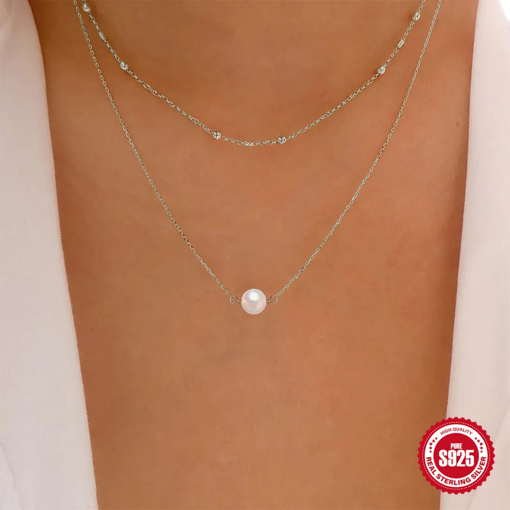 Sterling silver double layer necklace with twin pearls and geometric pendant in gold colour