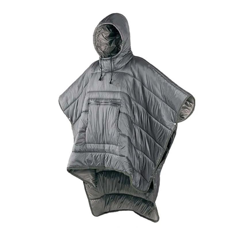 Adult wearing a gray hooded outdoor cloak that converts into a sleeping bag, shown laid flat at 200cm x 140cm.