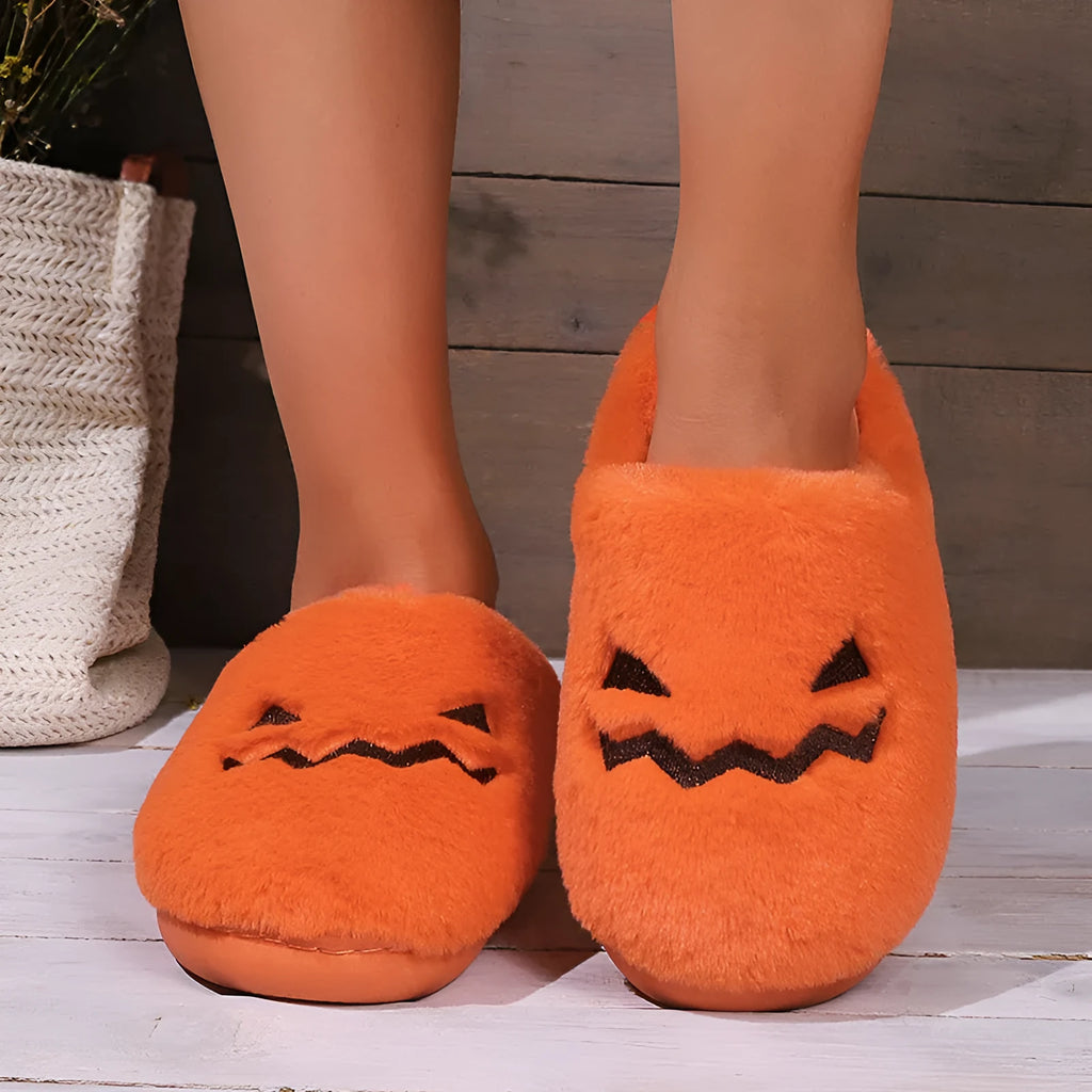 Orange Halloween pumpkin design plush slippers with coral velvet upper and non-slip sole.