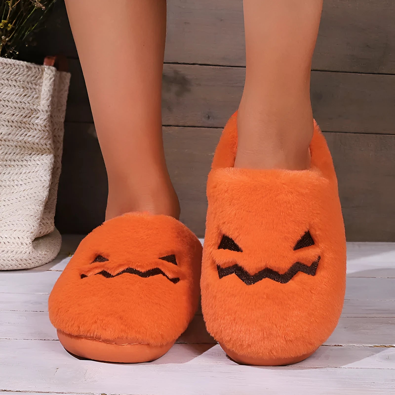 Orange Halloween pumpkin design plush slippers with coral velvet upper and non-slip sole.