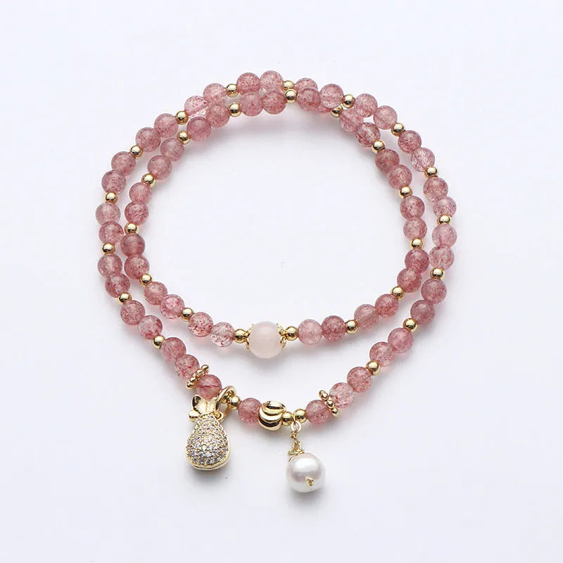Women's strawberry quartz crystal bracelet with geometric design on wrist