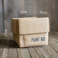 Cement brown paper box style floor planter with a drainage hole, shown in a Nordic indoor setting.