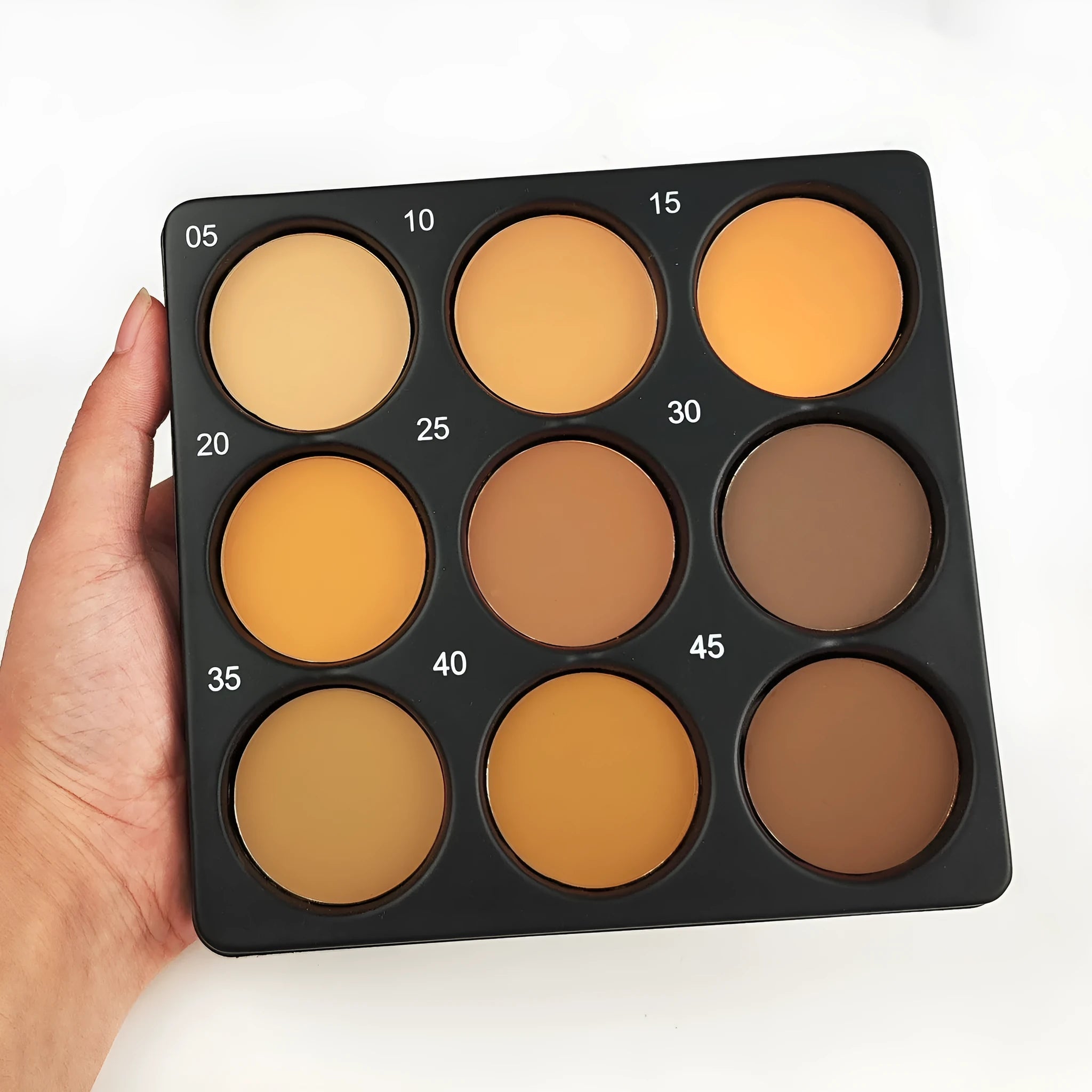 Dark matte 9-colour waterproof makeup palette compact open showing colour pans