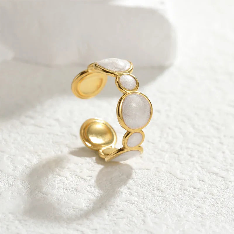 A geometric-shaped adjustable ring made from stainless steel with an electroplated metallic finish.