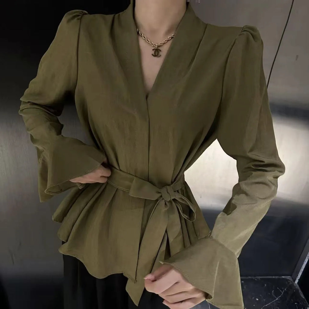 Women's black French-style shirt with an irregular collar, long flared bell sleeves, and a tied front closure.