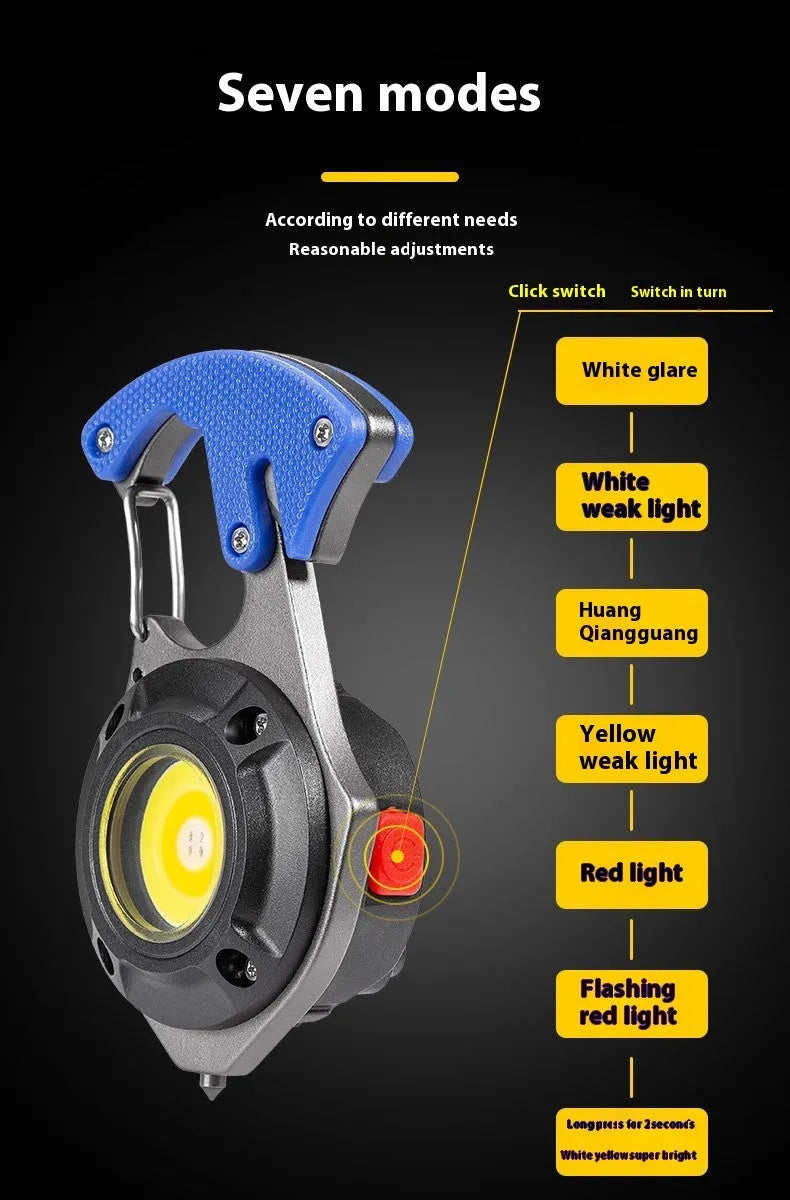 Compact silver and black multifunctional keychain flashlight with keyring, COB LED panel, and window breaker tool.
