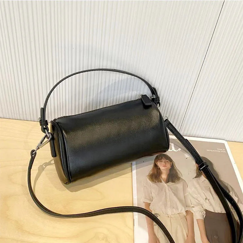 Genuine vegetable tanned leather crossbody phone bag with cylindrical shape and single shoulder strap