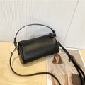 Genuine vegetable tanned leather crossbody phone bag with cylindrical shape and single shoulder strap