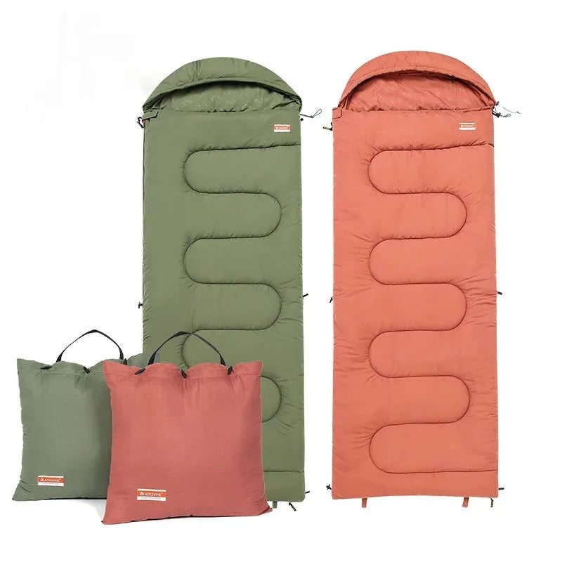 Cotton camping sleeping bag in ochre colour showing quilt-style construction and portable design