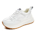 Beige women's low-top lace-up casual shoes with cowhide leather upper and cross strap detail.