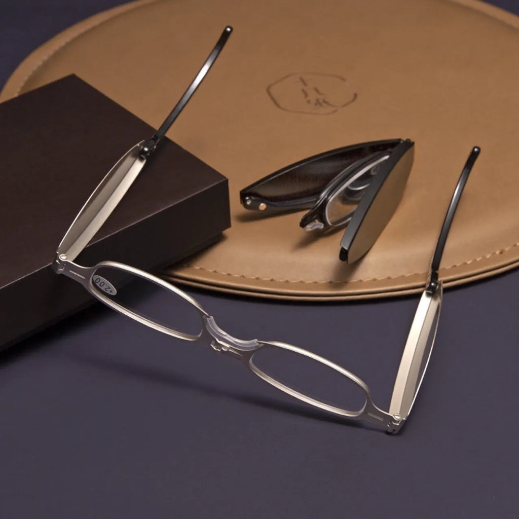 Folding pocket presbyopic glasses with retro ring-style metal frame in black or silver colour options.