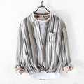 Grey striped linen shirt with long sleeves on male model showing loose casual fit