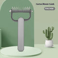 Green and grey pet hair unknotting comb for dogs with stainless steel teeth on a plastic handle.