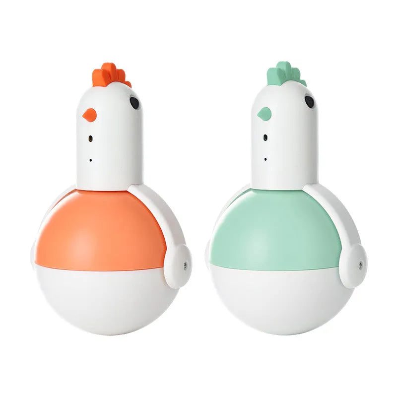 Green and orange electric cat toy chicken with laser and sound features on a flat surface.