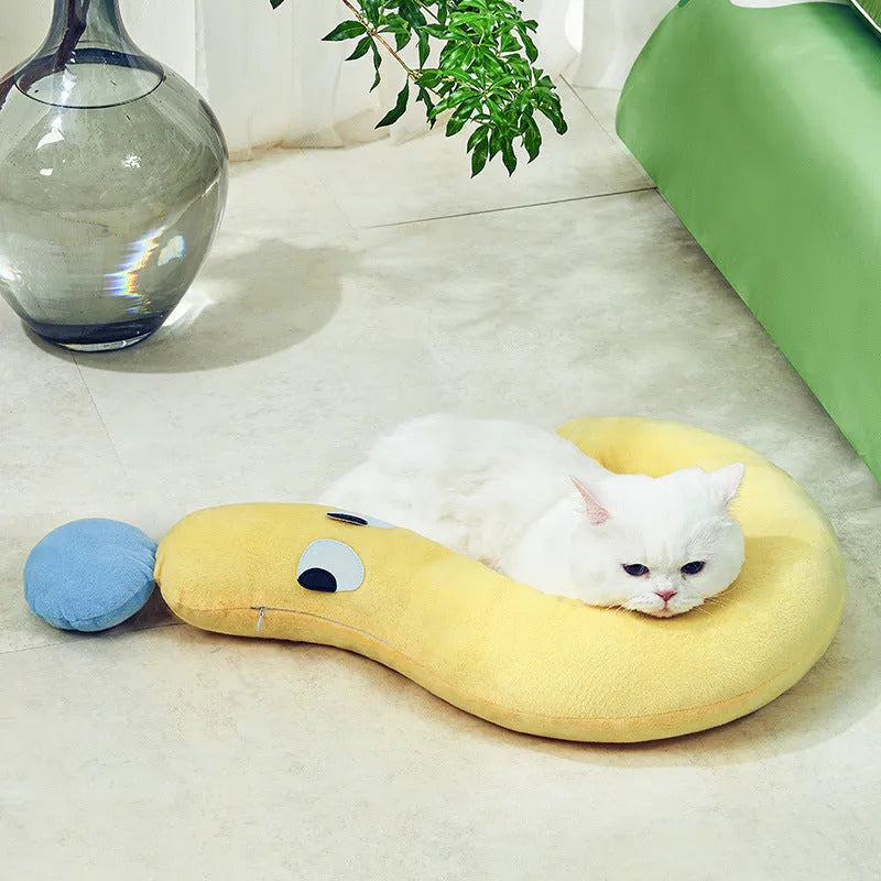 Blue rectangular pet cushion pillow for cats and dogs on a wooden floor.