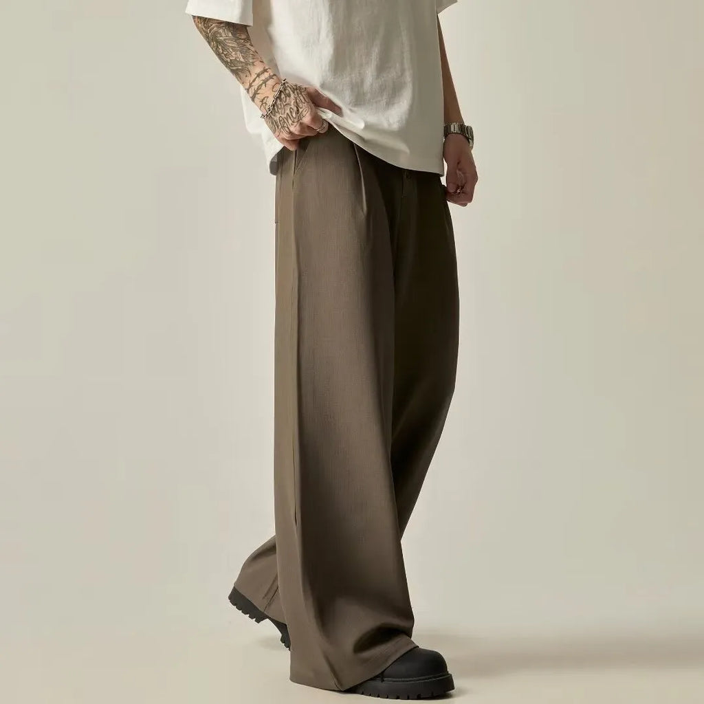 Men's black casual trousers with wide-leg design and button front in polyester cotton blend fabric