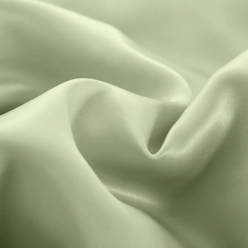 Double-sided silk duvet cover in solid colours showing lotus pink, pea green, and bright brown options