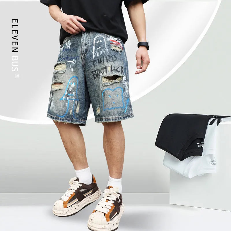 Men's blue ripped jeans shorts with graffiti detail, straight leg cut, and zipper fly closure