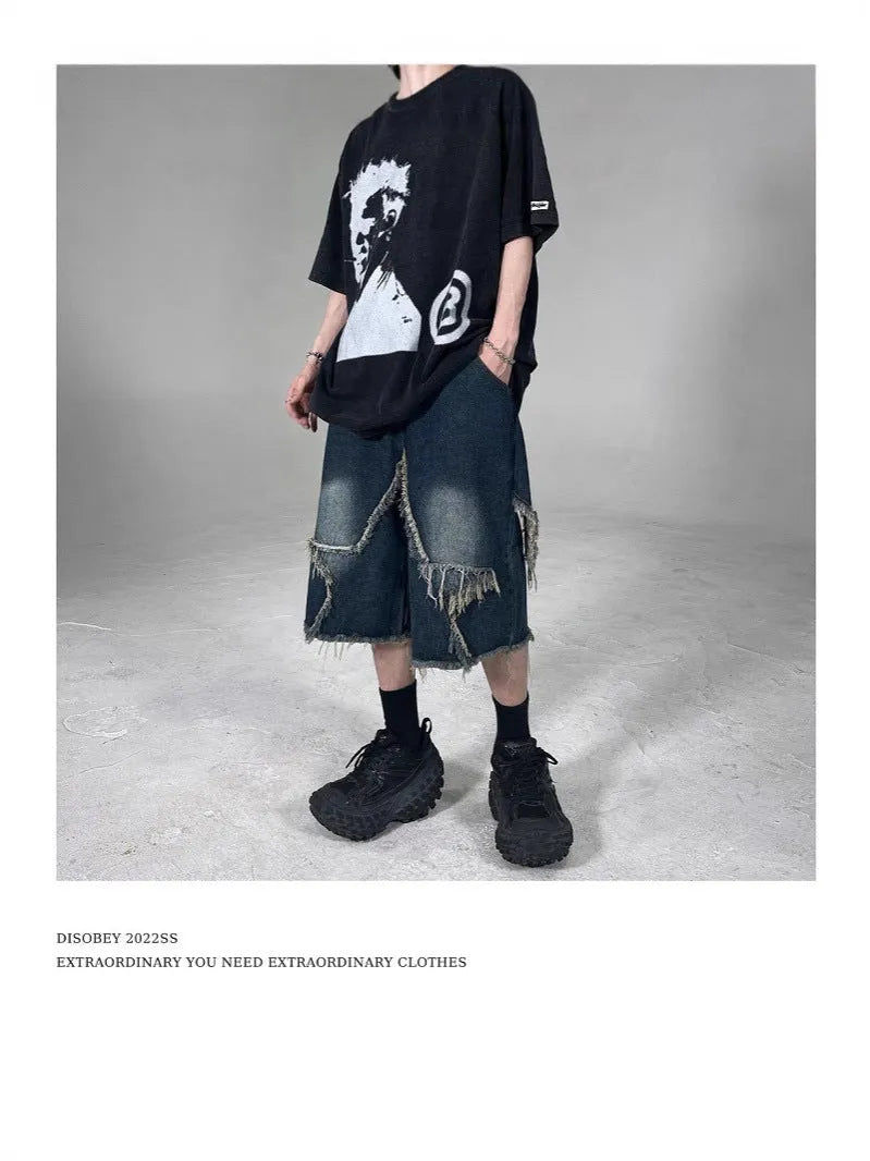 Blue denim shorts with frayed hem and five-pointed star detail, loose fit silhouette